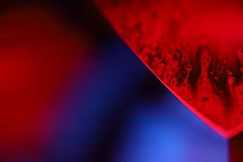 Red and purple liquid surface reflection, multicoloured art Stock Photos