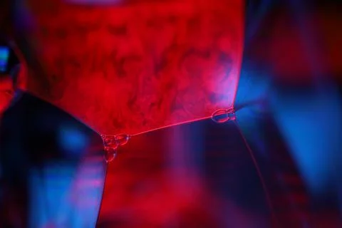 Red and purple liquid surface reflection, multicoloured art Stock Photos