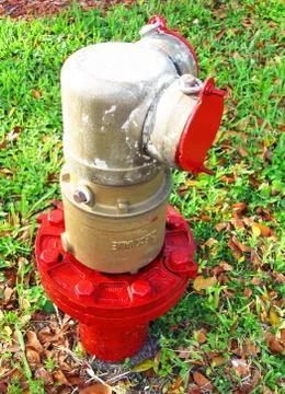 Red and Silver Fire Hydrant on a Public Street Stock Photos