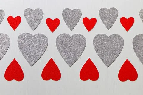 Red And Silver Hearts Pattern On Textured White Stock Photos