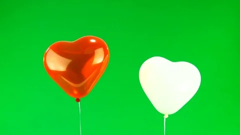 Red and white a balloon in the form of heart on the green screen Stock Footage 83346838