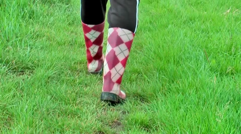 Red and white boot steps in the grass Stock Footage 36678979