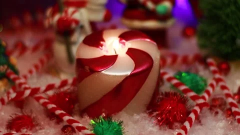 A red and white burning candle in a soft holiday scene Stock Footage 144415908