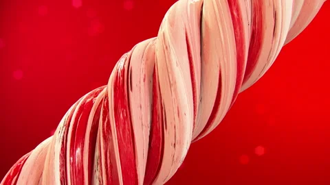 Red and white Candy Cane spinning on red background with copy space. Stock-Footage 283805151