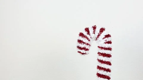 Red and white candy cane on white background, establisher Stock Footage 285197854