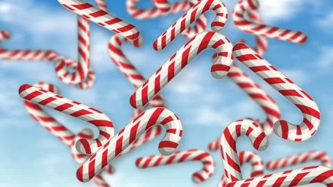 Red and White Candy Canes Falling Against a Blue Sky Background Stock Footage 345317069