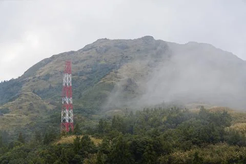 Red and White Cellular Tower on Yangmingshan Cloaked in Cloud Fotos Stock