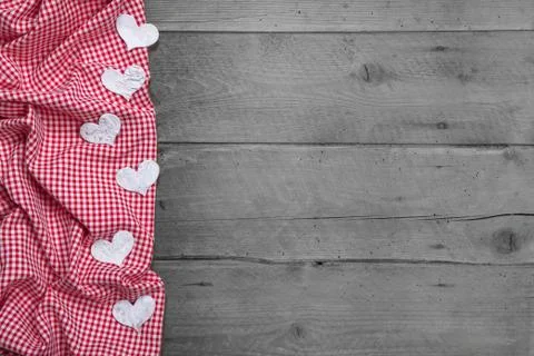 Red and white checkered frame with hearts on rustic wooden background - greet Foto stock