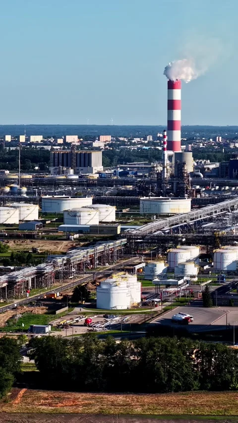 Red-and-White Chimney and Storage Tanks - ORLEN Płock - Mazovia - Poland Stock Footage 346586370