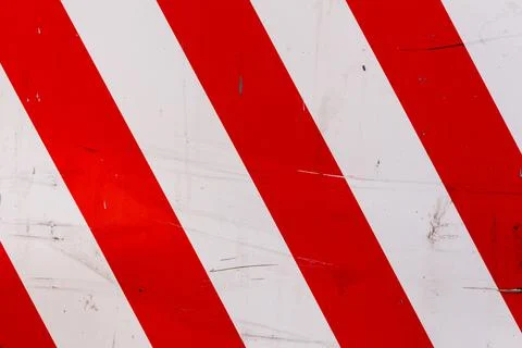 Red and white diagonal stipes on flat steel sheet - caution road sign 库存照片