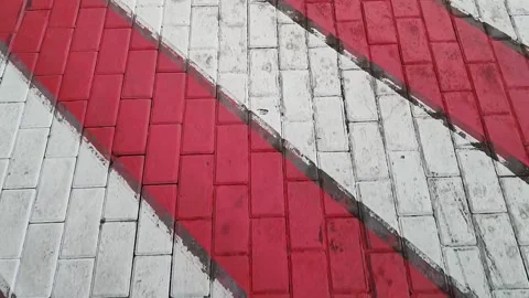 Red and white diagonal stripes on a road surface, indicating a designated area Видео 318605832