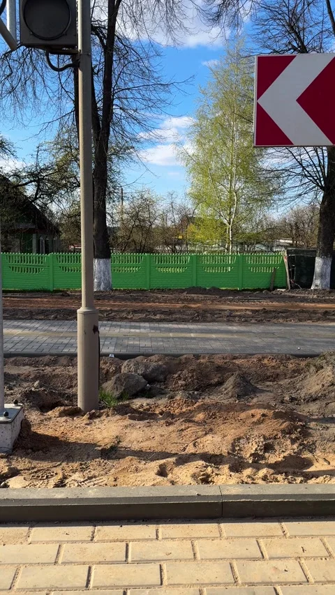 Red and white direction sign near sidewalk construction zone Stock-Footage 334628690