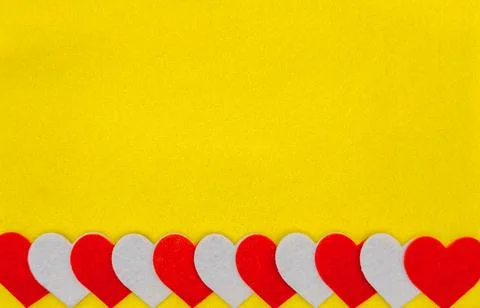 Red And White Felt Hearts Border On Yellow Background Stock Photos