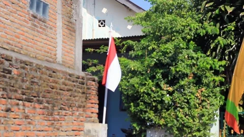 Red and white flag blowing in the wind Stock Footage 282228292
