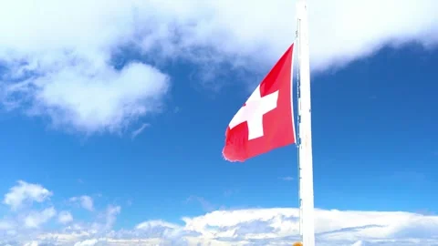 A red and white flag with a cross on it is flying in the sky Stock Footage 313555335