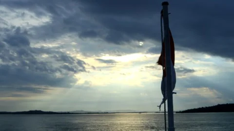 The red and white flag fluttering in the sea breeze above a ship Stock Footage 249712073