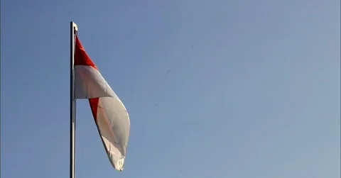 The red and white flag flutters in the blue sky on Independence Day Stock Footage 280814958