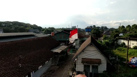 Red and white flag flying on pole in front of government office Stock-Footage 200141356