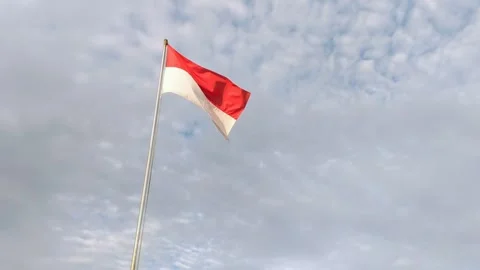 Red and white flag under white clouds Stock Footage 309659618