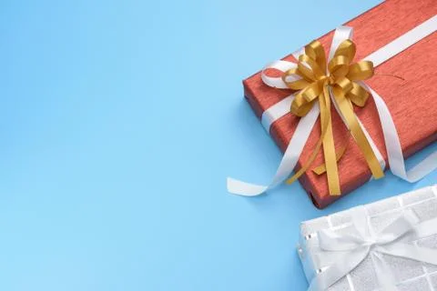 Red and white gift boxes with ribbon on blue background, top view Stock Photos