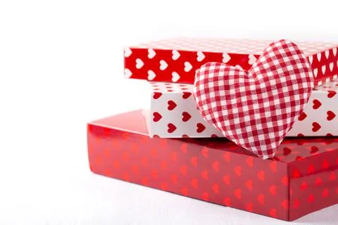 Red and white gift boxes with hearts on grey stone background, festive romant Stock Photos