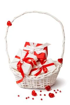 Red and white gift boxes in white basket. Stock Photos