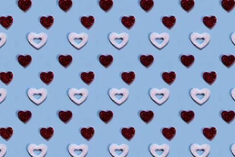 Red and white hearts pattern on blue background. Stock Photos
