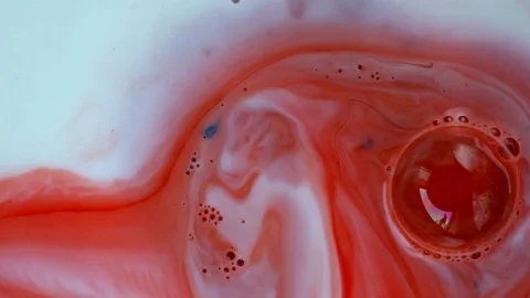 Red and white inks bubbles and mixed. Video Stockbeeldmateriaal 122417695