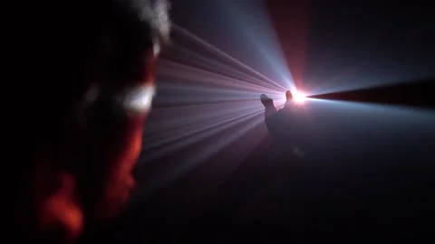 Red and White Light beams shine through a man's hand Stock Footage 170833093