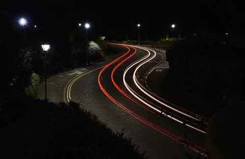Red and white light trails on an s bend Stock Photos