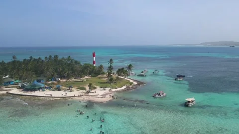 Red and white lighthouse and turquoise sea on San Andres island Stock Footage 331255262