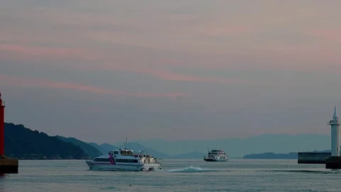 Red and White Lighthouses Shining at Dusk with High-Speed Boat, Ferry, 4K Video stock 344440583