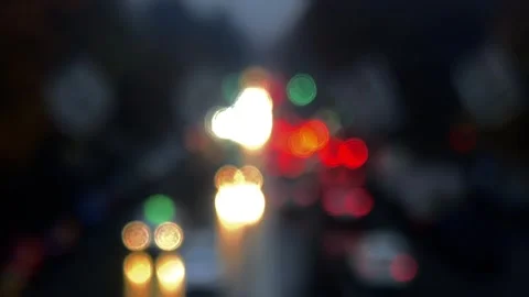 Red and white lights bokeh. Cars flow out of focus on road on street Stock Footage 295697154