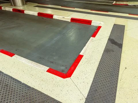 Red and white lines define the loading area in a parking lot. The smooth conc Stock Photos