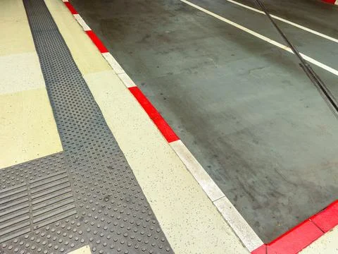 Red and white lines indicate boundaries in a parking lot. The surface has tex Stock Photos