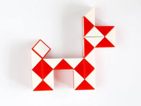 Red and white magic snake twist puzzle in shape of dog isolated Stock Photos