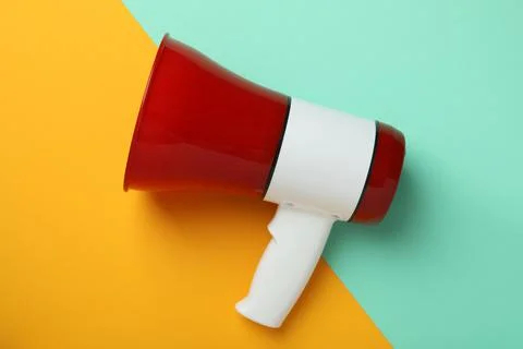 Red and white megaphone on two tone background Stock Photos