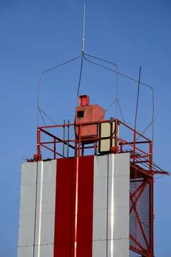 Red and White Navigation Beacon Tower Rising Above Modern Stock Photos