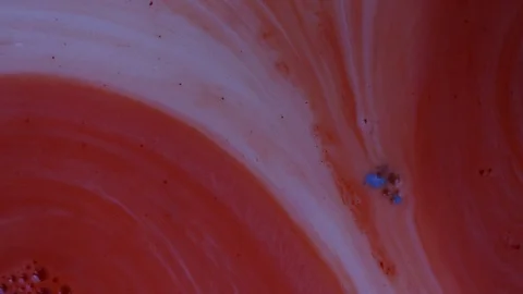Red and white paints spread out. Video with copyspace Stock Footage