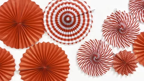 Red and white paper fan decorations on white background. 스톡 동영상 345557785