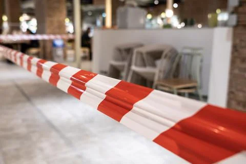 Red and White Plastic Caution tape around store close due covid-19 pandemic,S Stock Photos