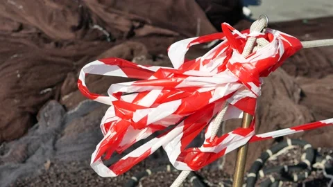 Red and white plastic tape moved from wind Stock Footage 151836799