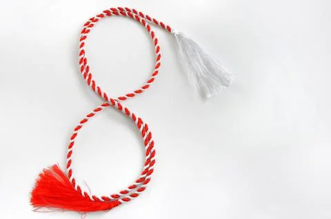 Red and white ribbon in shape of figure 8 on white background Stock Photos