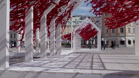 Red and white ribbons flutter in the wind on Dome Square in Riga, Latvia. Stock Footage 309553766