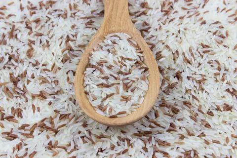 Red and white rice on spoon Stock Photos