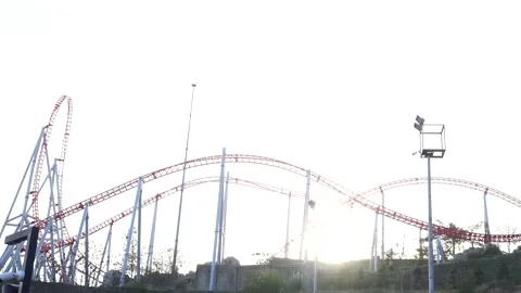 Red and white roller coaster track against bright sky Stock Footage 321008146