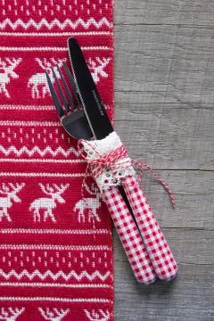 Red and white rustic table decoration with wood for christmas - cutlery. Stock Photos