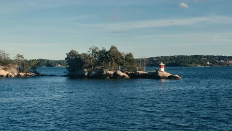 Red and White Small Lighthouse on Stockholm Archipelago Island Видео 122375928