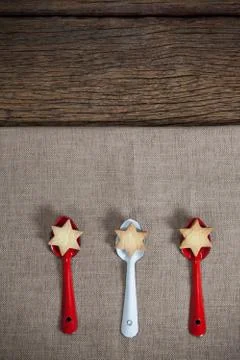 Red and white spoon with christmas cookies Stock Photos