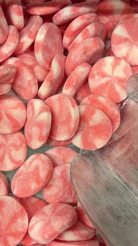 Red and White Striped Candy Falling on a Sweets Pile in Slow Motion as Perfect Stock Footage 316079014